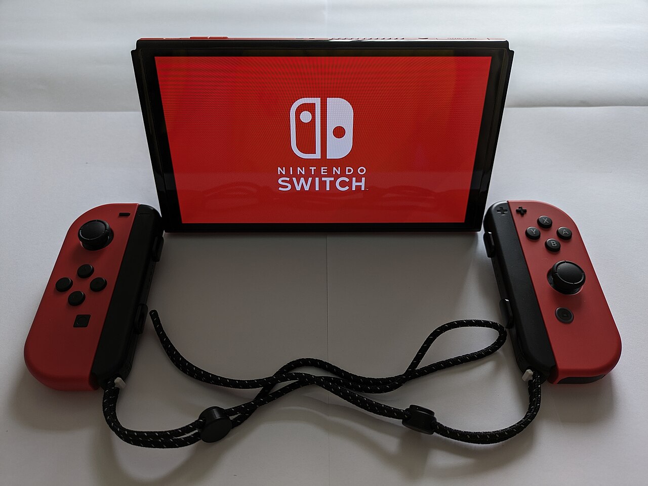 A Nintendo Switch console with red Joy-Con controllers