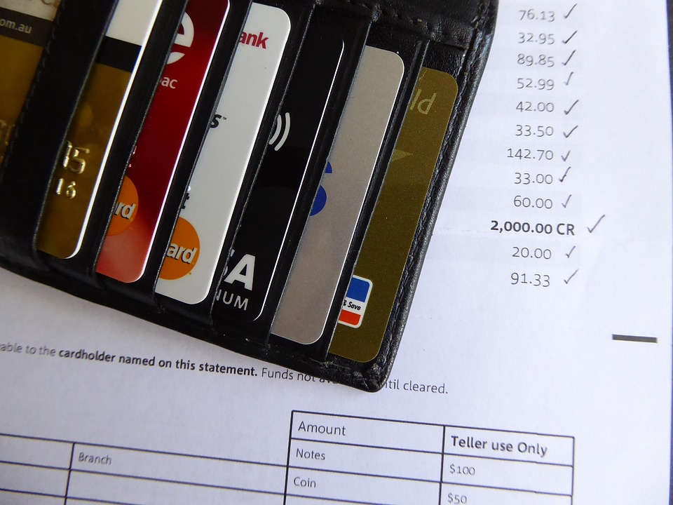 Credit cards placed over a printed bank statement